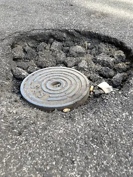 Allarme in via Papale a Catania: buca si allarga e tombino scoperto mettono a rischio auto e due ruote